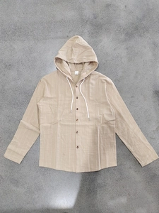 Flat lay detail showing the striped linen hood and cotton blend fabric texture on beige shirt