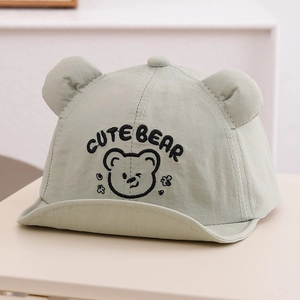 Detailed embroidery of a cute bear face and ears on a green breathable baby baseball cap
