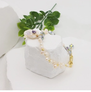 Detail shot of baroque freshwater pearls and aurora crystal beads on an elegant bracelet