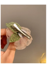 Detail showing the silver metal duckbill clip back of a handmade pink mesh floral hairpin