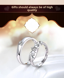 Detailed view of silver couple rings with minimalist male band and winged female ring set