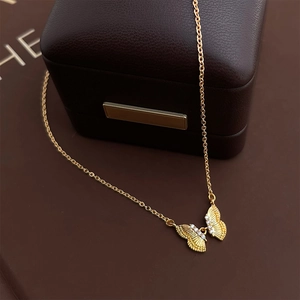 Close-up of butterfly pendant with intricate textures and sparkling white zircon stones