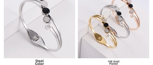 Detail of three-line elastic spring bangle in 18K gold and steel finish with rhinestones