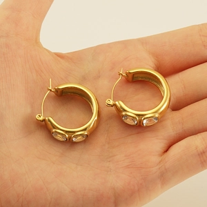 Chunky 18k gold plated stainless steel hoop earrings with oval zircon stones in hand
