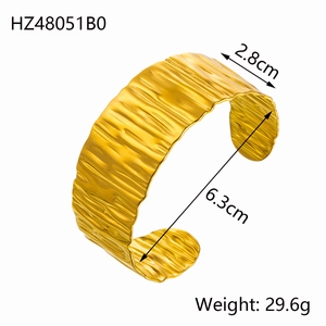 Detail showing irregular ripple texture on 18k gold plated stainless steel wide cuff