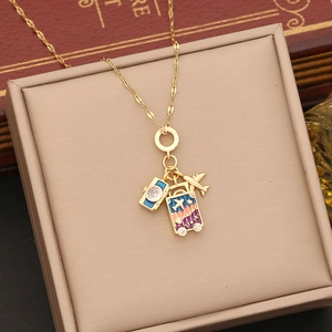 Gold travel pendant necklace with camera, airplane and Happy Travel suitcase charms