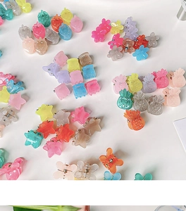 Detail of colorful translucent plastic mini hair clips in star and flower shapes