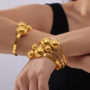 Polished gold beaded spring open bangle in titanium steel for women in modern style