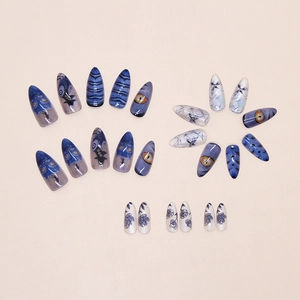 Macro detail of long stiletto press on nails with blue Avatar themed character designs