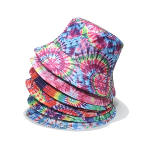 Detailed stack of colorful tie-dye bucket hats with rainbow spiral patterns and reinforced stitching