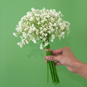Artificial white baby's breath flower bouquet with green stems and twine binding