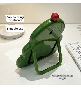 Rear view of green decorative mirror showing adjustable fold-out stand and wall-mount hole