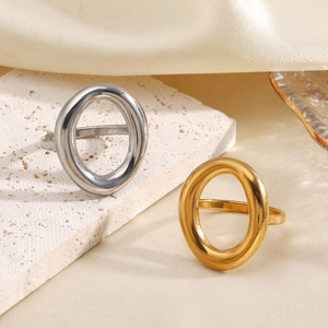 Polished 18K gold and silver chunky hollow oval geometric rings on elegant background