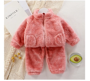 Flat lay of pink plush thermal kids loungewear set with zipper top and matching pants