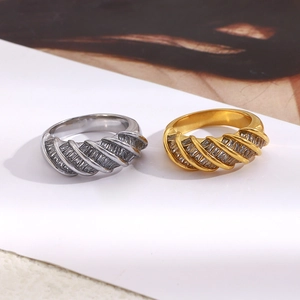 Detail of twisted 18K gold and silver plated rings with rectangular zircon stones