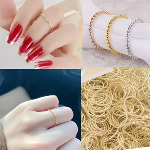 Detailed view of twisted cable rings in gold, silver, and rose gold stainless steel