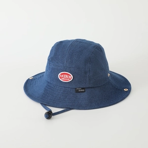 Detailed view of denim bucket hat featuring red label, stitching, and adjustable chin strap