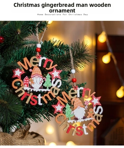 Detail of wooden Merry Christmas ornaments with gnome and gingerbread man on a tree