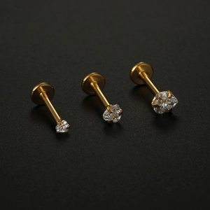 Three gold titanium steel labret studs with cubic zirconia in different sizes