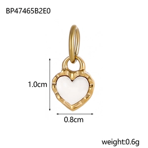 Macro view of a gold heart pendant with white inlay showing dimensions 1.0cm x 0.8cm