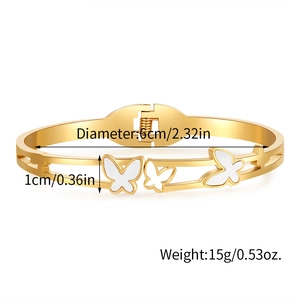 Detail showing dimensions of golden butterfly bangle with white inlay on white background