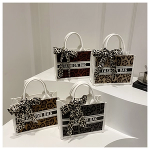 Detail of leopard print tote bags in four colors with matching decorative scarves