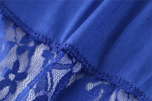 Detailed close-up of royal blue lace stitching and soft knit fabric texture