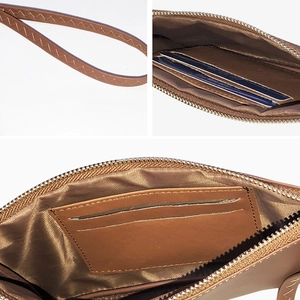 Brown leather long wallet for women featuring wrist strap and multi-slot interior organizer