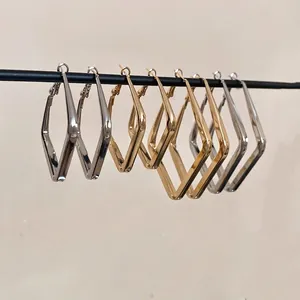 Polished gold and silver geometric diamond-shaped hoop earrings for women shown together