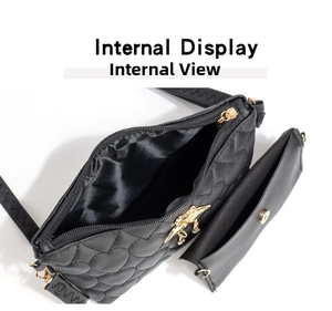 Internal view of black heart-quilted crossbody bag showing spacious main compartment