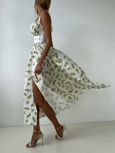 Detail of floral sundress with lemon print featuring high slit and cinched waist design
