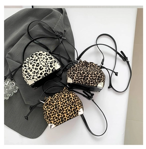 Detail of leopard print bucket bags showing drawstring closure and silver metal corners
