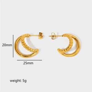 Detail view of gold C-shaped twisted hoop earrings with 25mm diameter and 20mm height