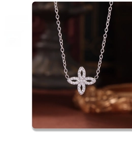 Macro shot of silver four-leaf clover pendant with sparkling zircon micro-inlaid stones