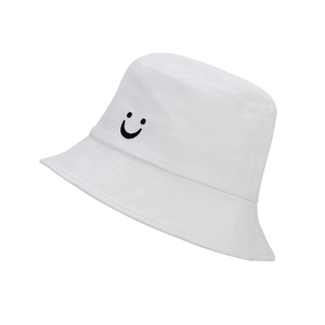 Close-up of a white canvas bucket hat featuring a black embroidered smiley face detail