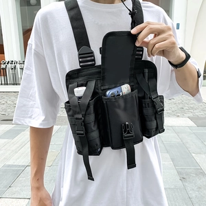 Detailed view of black nylon tactical chest bag with MOLLE system and functional pockets
