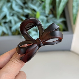 Detailed view of matte tortoise shell bow hair claw clip with strong metal spring