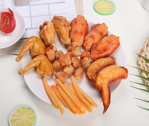 Realistic PVC roasted chicken wings and fries food models displayed on a white plate