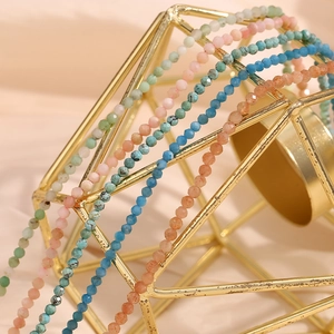 Detailed close-up of faceted colorful natural stone beads on 18K gold plated chains