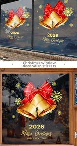 Detail of 2026 Christmas window sticker with golden bells and red bows on glass