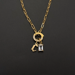 Close-up of 14K gold plated paperclip chain with rhinestone letter C and rectangular charm