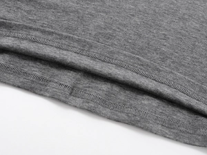 Detailed macro view of the double-stitched hem and wool blend fabric on a grey t-shirt