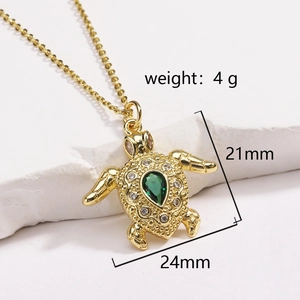 Detailed view of turtle pendant size 21mm by 24mm with green gem and gold chain