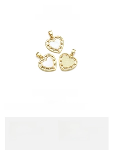 Detail of 19x20mm heart pendant with natural shell and gold plated finish on copper