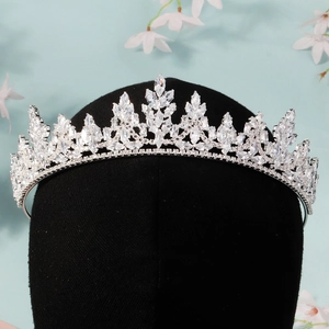 Detail shot of a silver bridal crown with shimmering zircons on a display stand