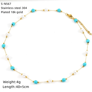 Detail of 18K gold-plated stainless steel necklace with turquoise and pearl accents