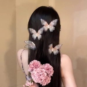 Detailed view of translucent butterfly hair clips with elegant pearls and long ribbons