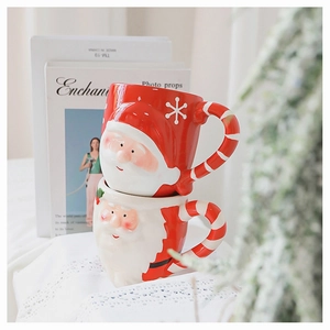 Detail of 3D embossed Santa Claus ceramic mug with red and white striped handle
