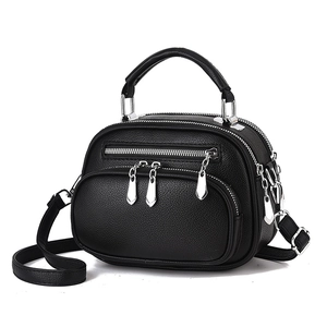 Minimalist black lychee texture crossbody bag with triple zippers and silver hardware