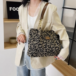 Large leopard print tote bag with brown leather and chain straps for stylish commuting